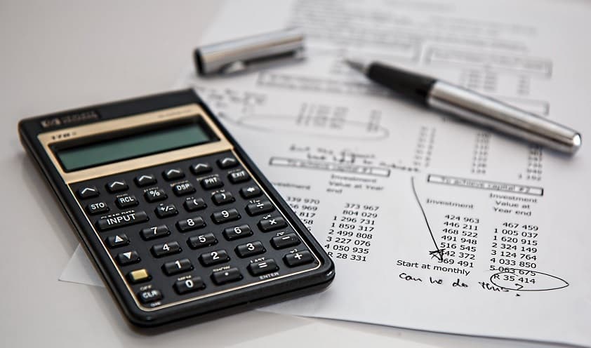 Calculator and pen on financial documents